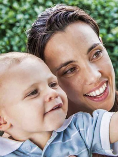 Mother and son observing a butterfly at Dubai Butterfly Garden.