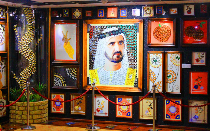 Butterfly art display at Dubai Butterfly Garden featuring intricate designs and portraits.