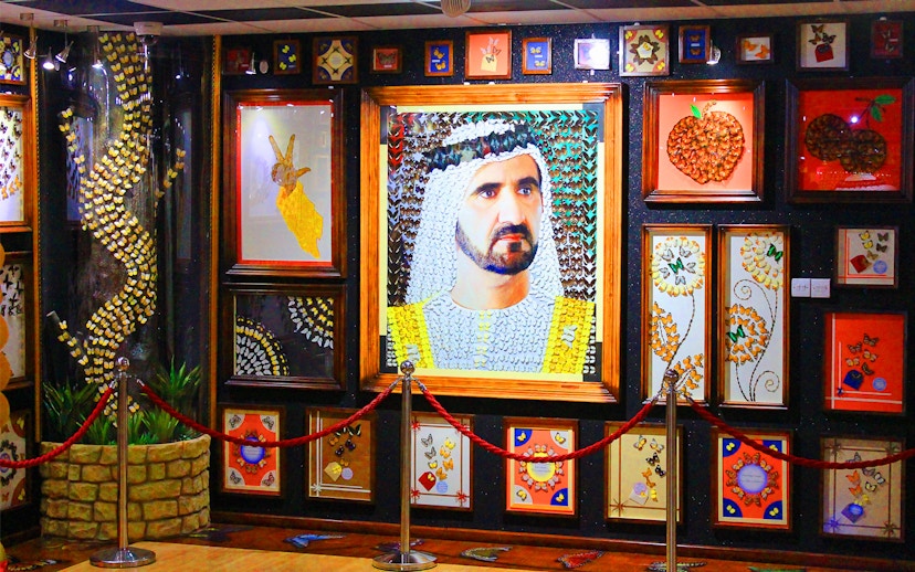 Butterfly art display at Dubai Butterfly Garden featuring intricate designs and portraits.