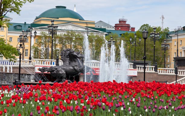 Fountain and horse statue with tulips in Moscow near the Kremlin.