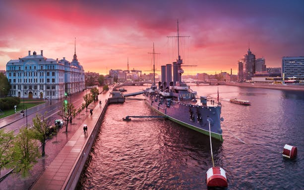 Cruiser Aurora docked on the Neva River at sunset, Saint Petersburg, Russia.