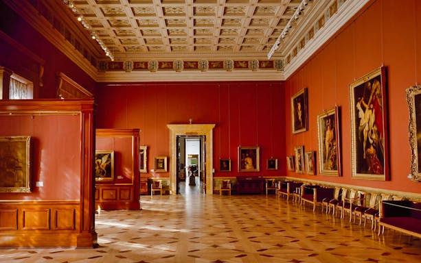 Hermitage Museum gallery with classic paintings and ornate ceiling, St. Petersburg.