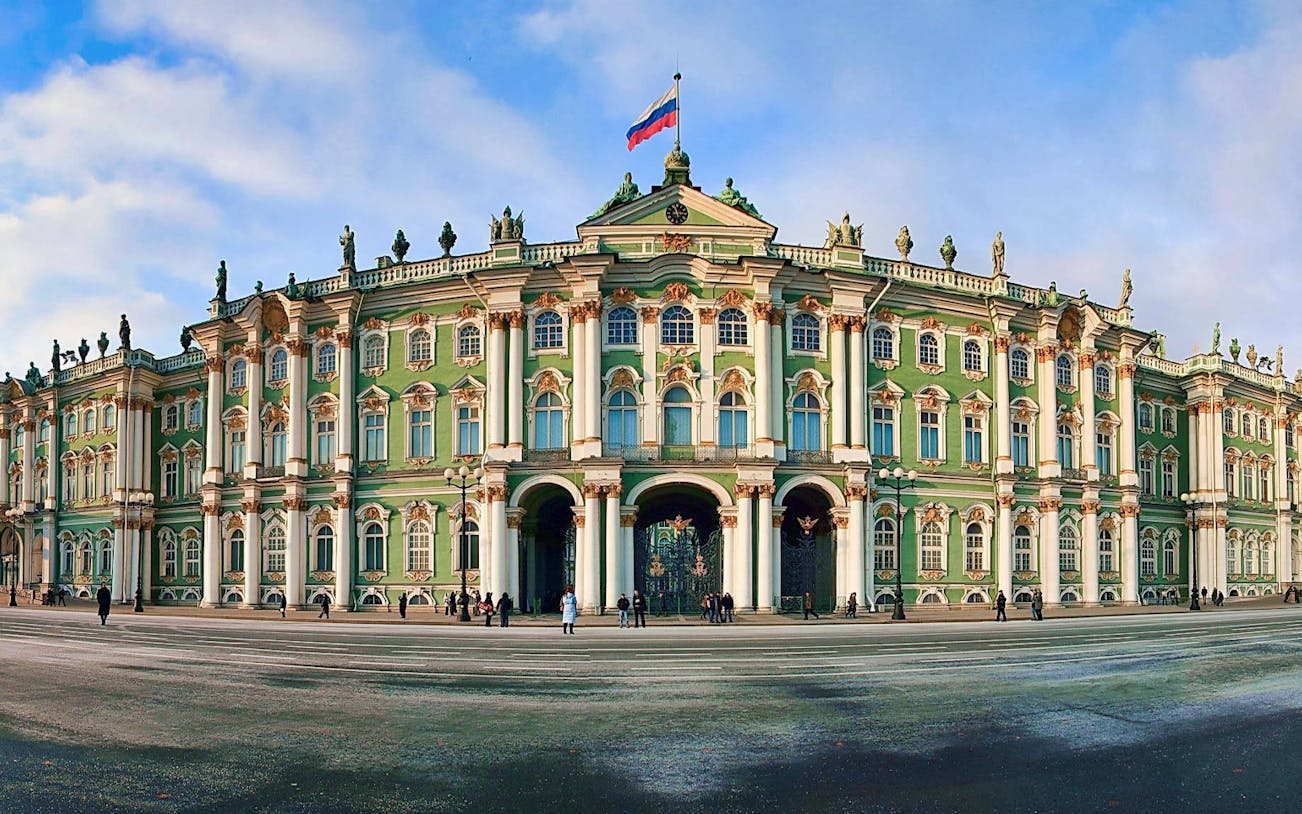 Hermitage Museum facade in Saint Petersburg, Russia, with people outside.