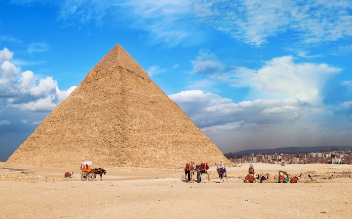 Quad bikes and camels near the Great Pyramid of Giza, Egypt.