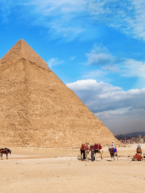 Quad bikes and camels near the Great Pyramid of Giza, Egypt.