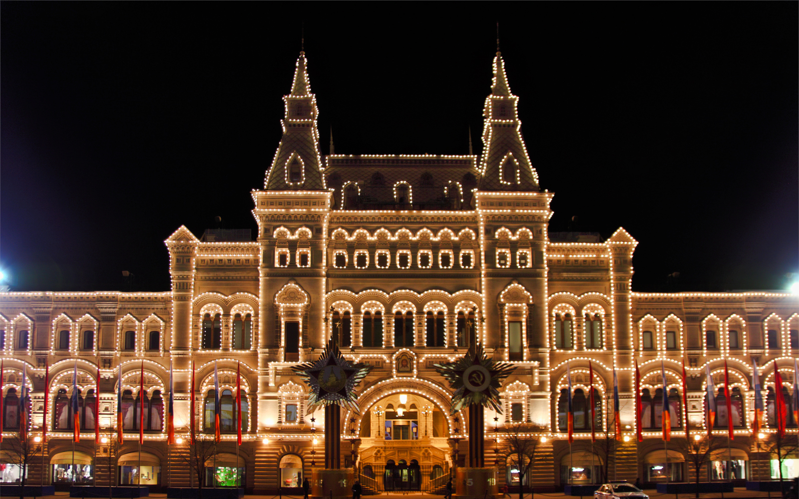 Illuminated GUM department store at night during Moscow city tour.