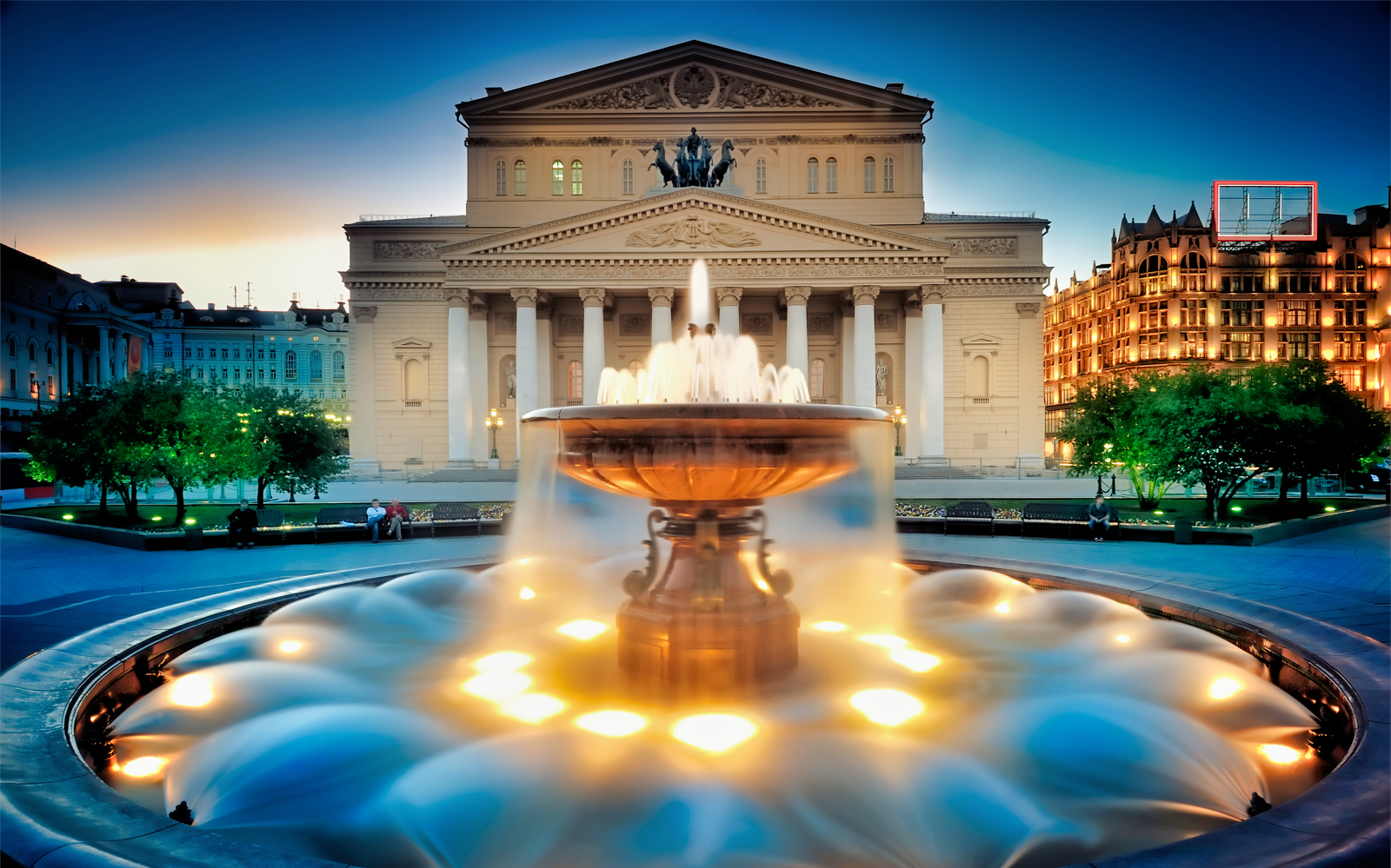 Bolshoi Theatre and illuminated fountain at dusk, Moscow.