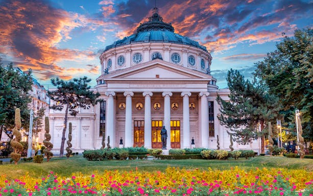 Romanian Athenaeum in Bucharest at sunset, part of city sightseeing tour.