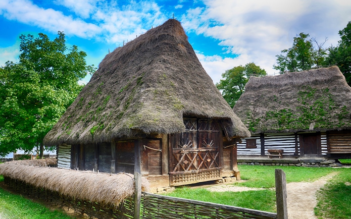 Traditional thatched-roof houses at the Village Museum in Bucharest.