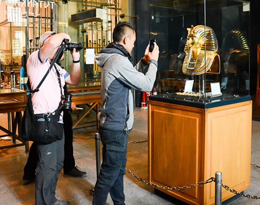 Visitors photographing Tutankhamun's mask at the Egyptian Museum, Cairo.