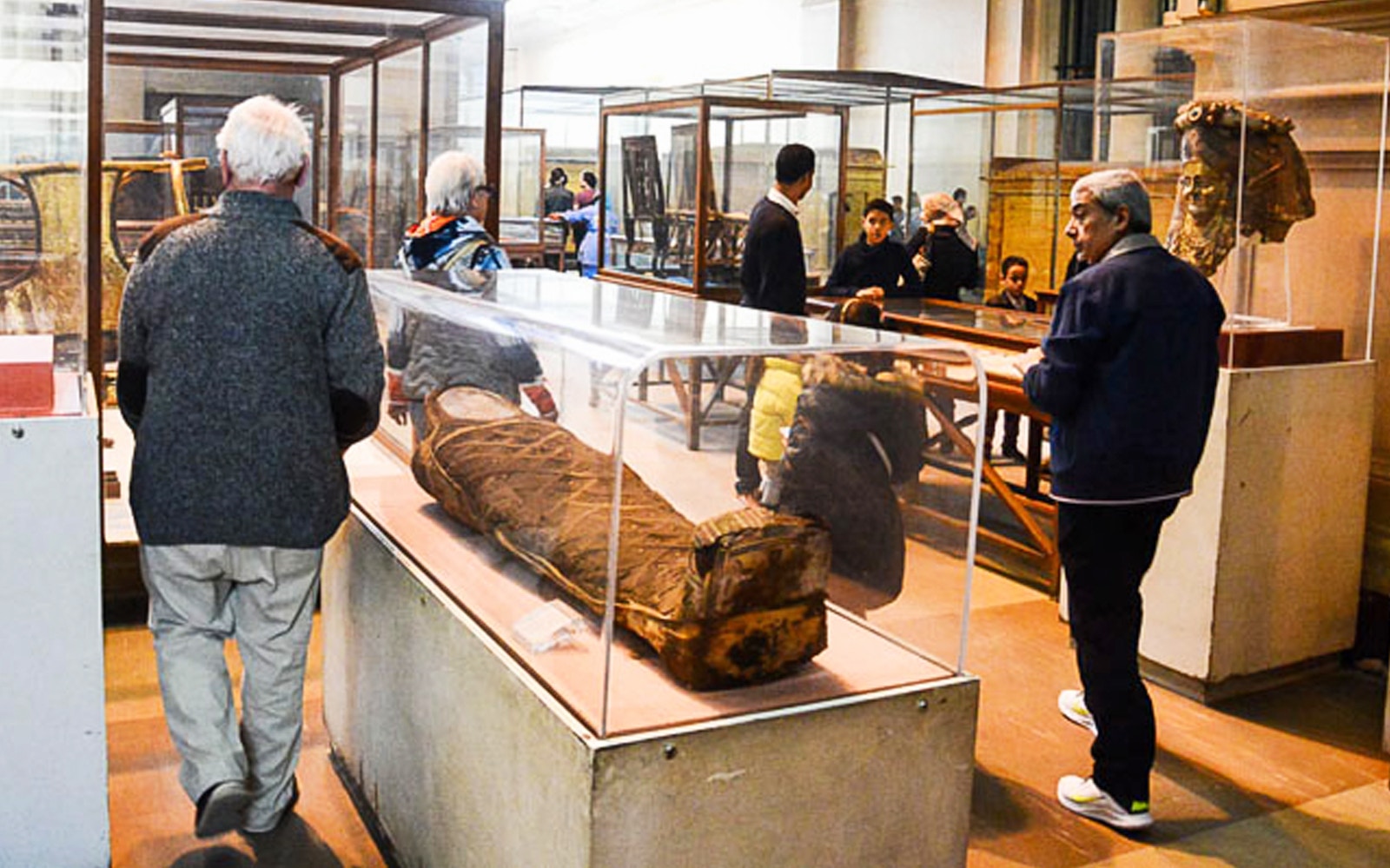 Visitors viewing ancient artifacts in the Egyptian Museum, Cairo, during the Giza Pyramids tour.