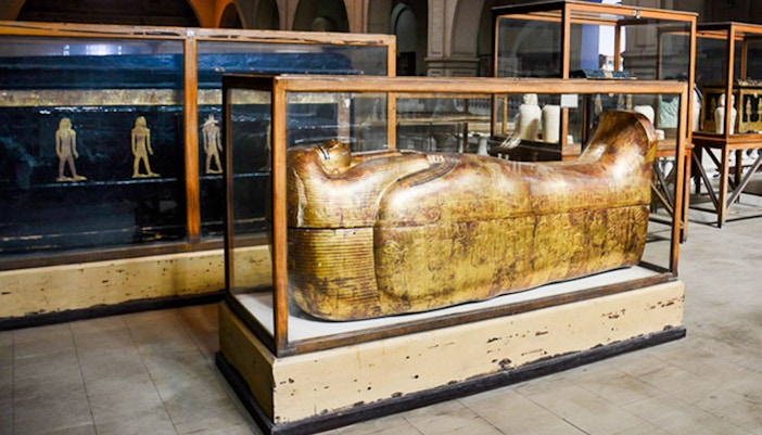 Golden sarcophagus display at the Egyptian Museum, Cairo, part of the Giza Pyramids and Egyptian Museum tour.