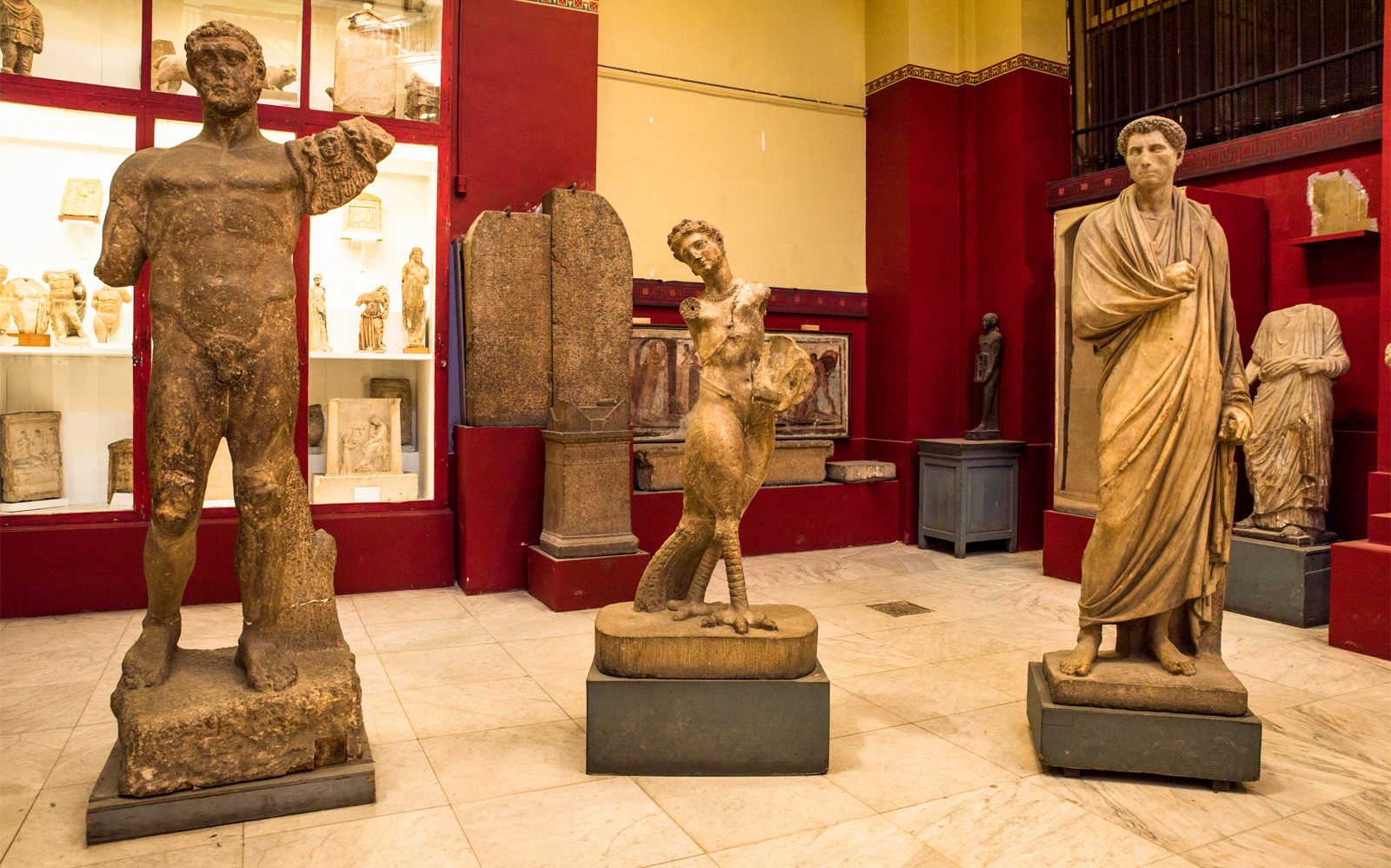 Ancient statues displayed in the Egyptian Museum during a guided tour.