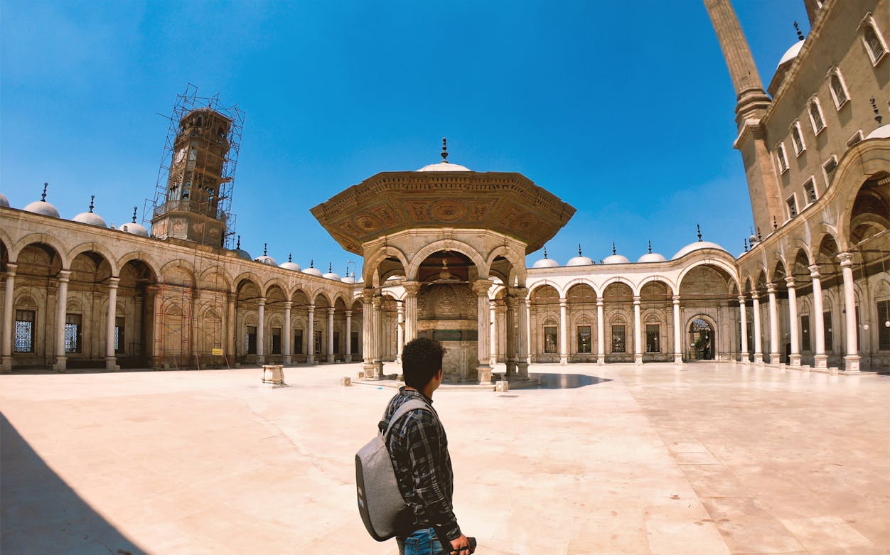 Tourist exploring the courtyard of the Citadel in Cairo, Egypt.