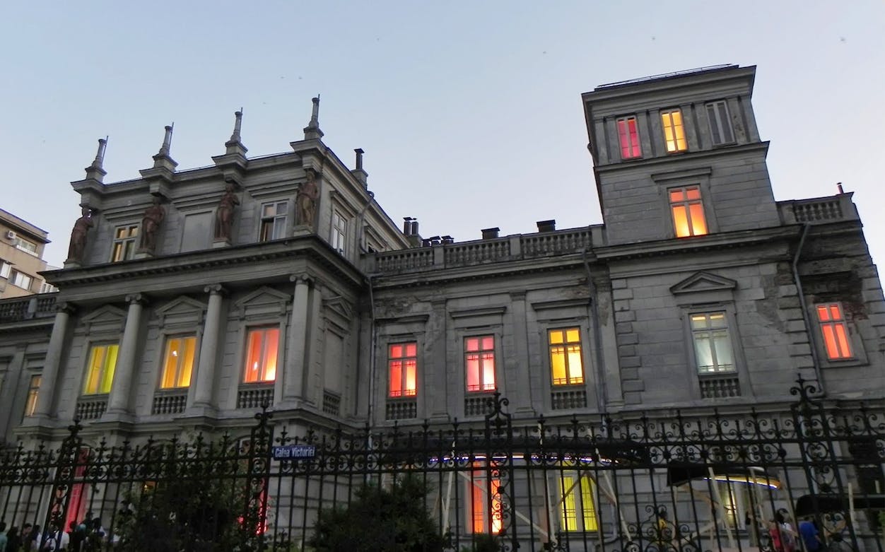 Historic building with colorful lit windows on Calea Victoriei, Bucharest, part of the Underground City tour.