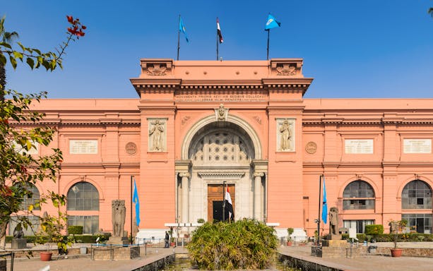 Egyptian Museum entrance with flags and statues, Cairo, for skip the line guided tour.