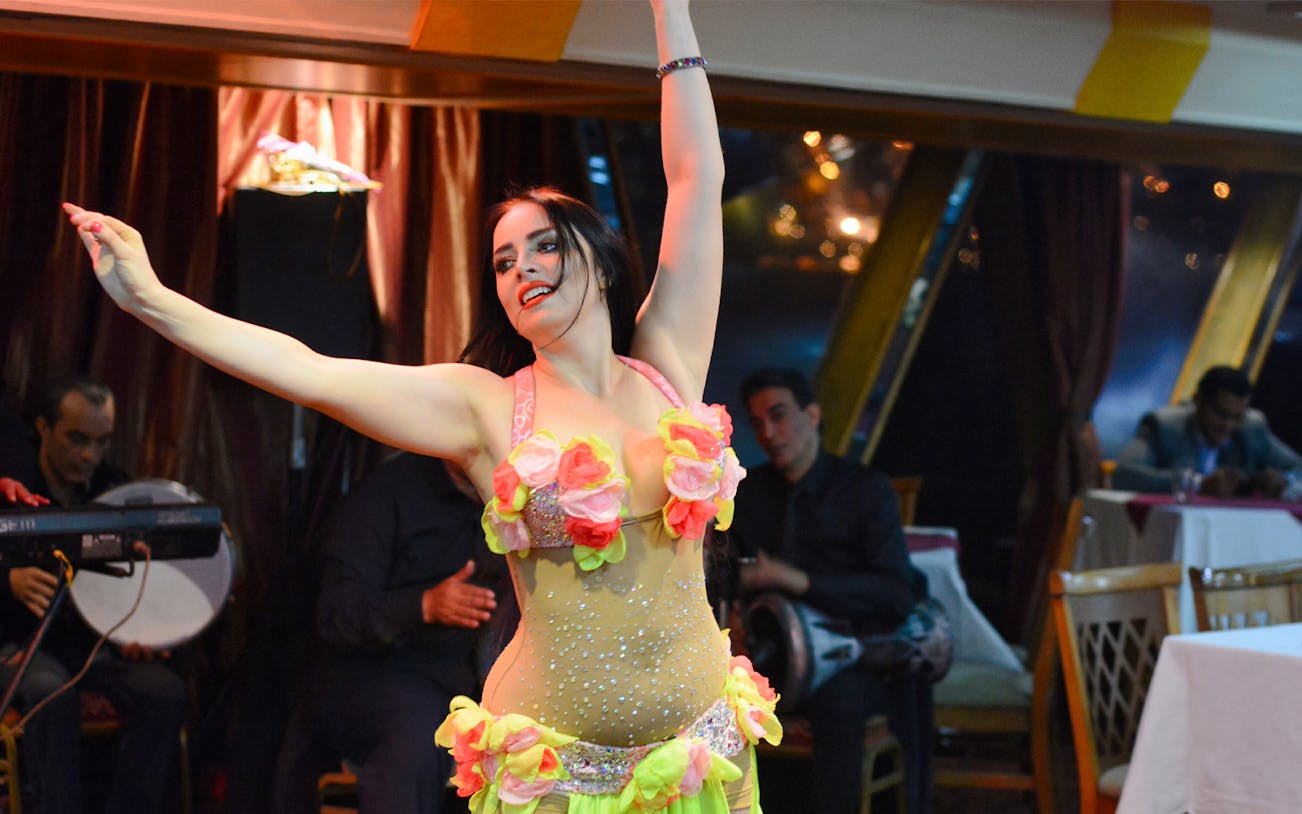 Dancer performing on a Nile River dinner cruise with live music entertainment.
