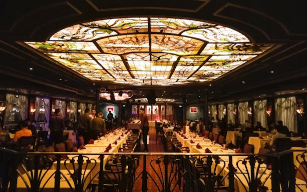 Luxurious dining area on the Nile Maxim dinner cruise with stained glass ceiling.