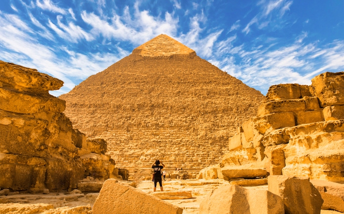 Pyramid of Giza with a person standing in front, Egypt tour experience.