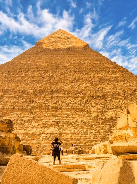 Pyramid of Giza with a person standing in front, Egypt tour experience.