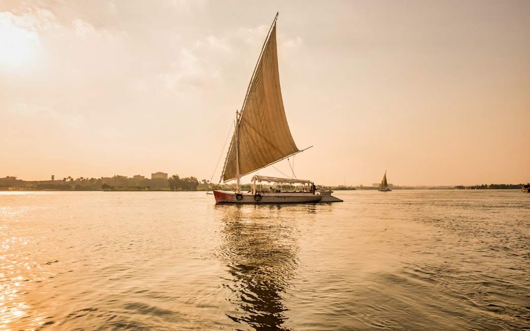 Felucca sailing on the River Nile during sunset in Egypt.
