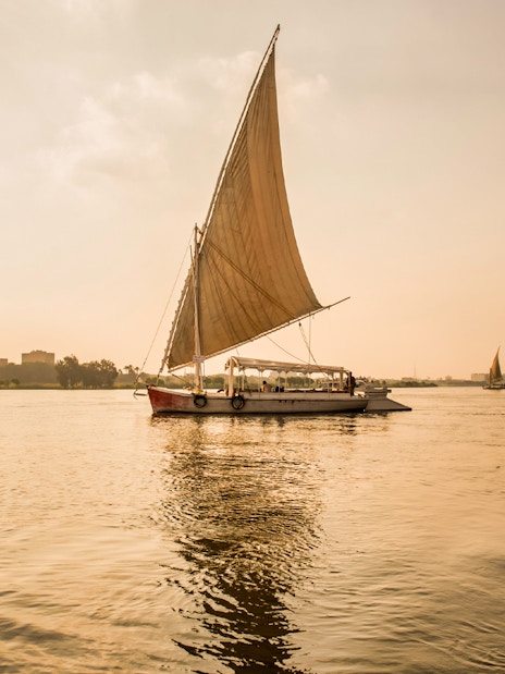 Felucca sailing on the River Nile during sunset in Egypt.