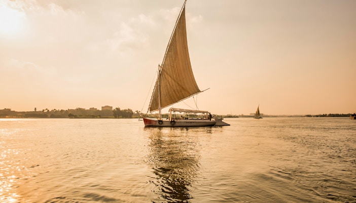 Felucca sailing on the River Nile during sunset in Egypt.