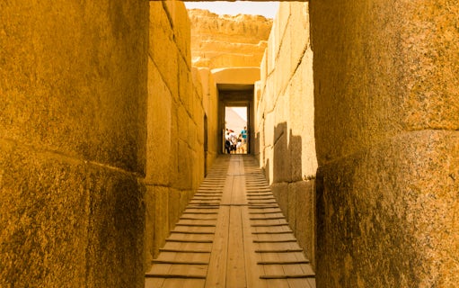 Pathway through ancient stone corridor leading to the Pyramids, Egypt.