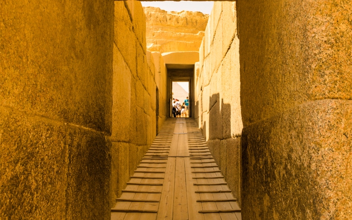 Pathway through ancient stone corridor leading to the Pyramids, Egypt.