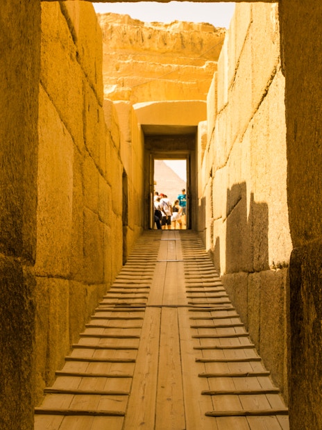 Pathway through ancient stone corridor leading to the Pyramids, Egypt.