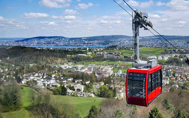 Cable car over Zürich landscape during evening tour with gourmet dinner and cheese fondue.