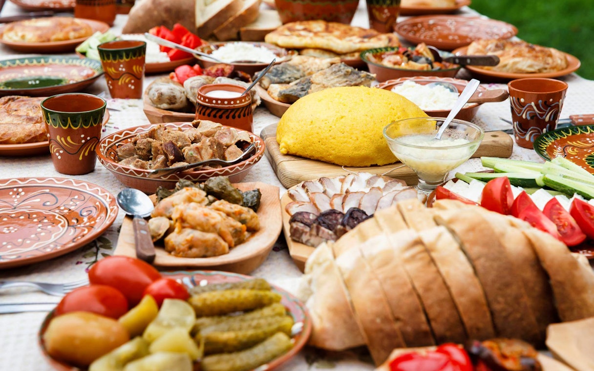 Traditional dinner spread with various dishes and bread, part of the After Dark City Tour.