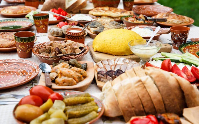 Traditional dinner spread with various dishes and bread, part of the After Dark City Tour.