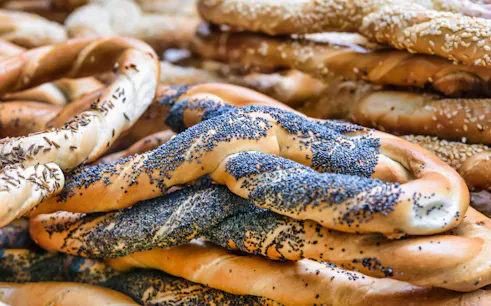 Poppy seed-covered pretzels on the Unhealthy Food Tour of Bucharest.