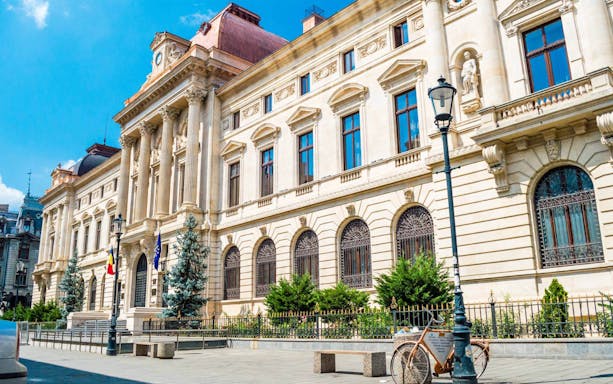 Bucharest city street with historic building, part of Unhealthy Food Tour.