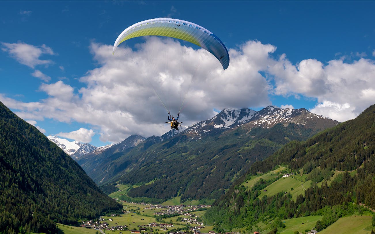 Tandem paragliding over the scenic mountains of Tirol, Austria.