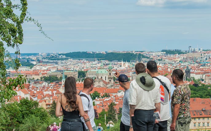 Tourists overlooking Prague's skyline with St. Nicholas Church on One Prague Tour: The Castle Side.