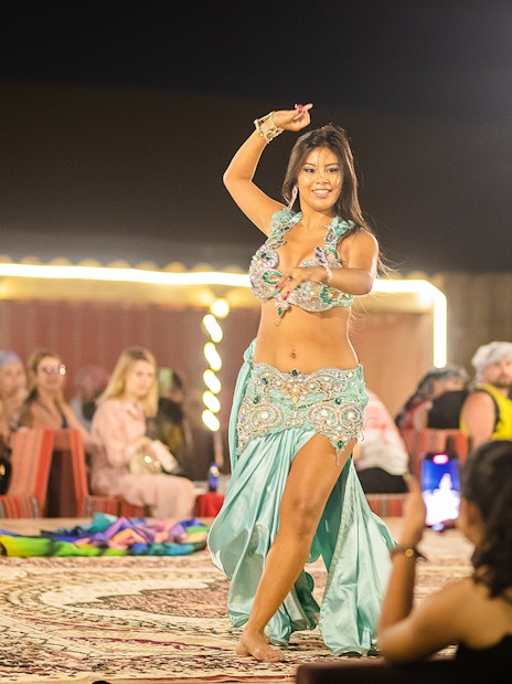 Belly dancer performing at a Dubai desert safari evening show.