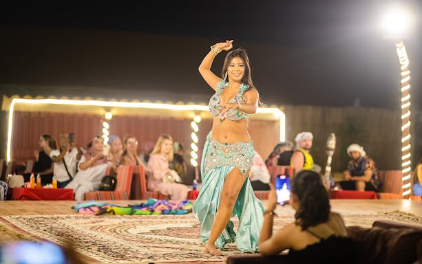 Belly dancer performing at a Dubai desert safari evening show.