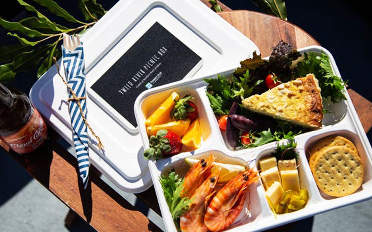 Lunch box with prawns, quiche, salad, and fruit on Tweed River Rainforest Cruise.