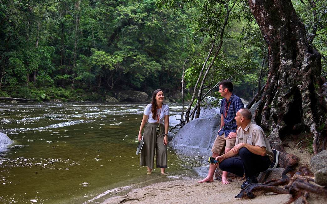 Tourists enjoying a guided walk by the river in Daintree Rainforest, Cape Tribulation.