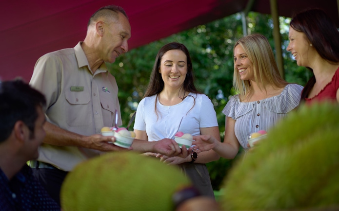Tour guide sharing desserts with visitors during Cape Tribulation tour.