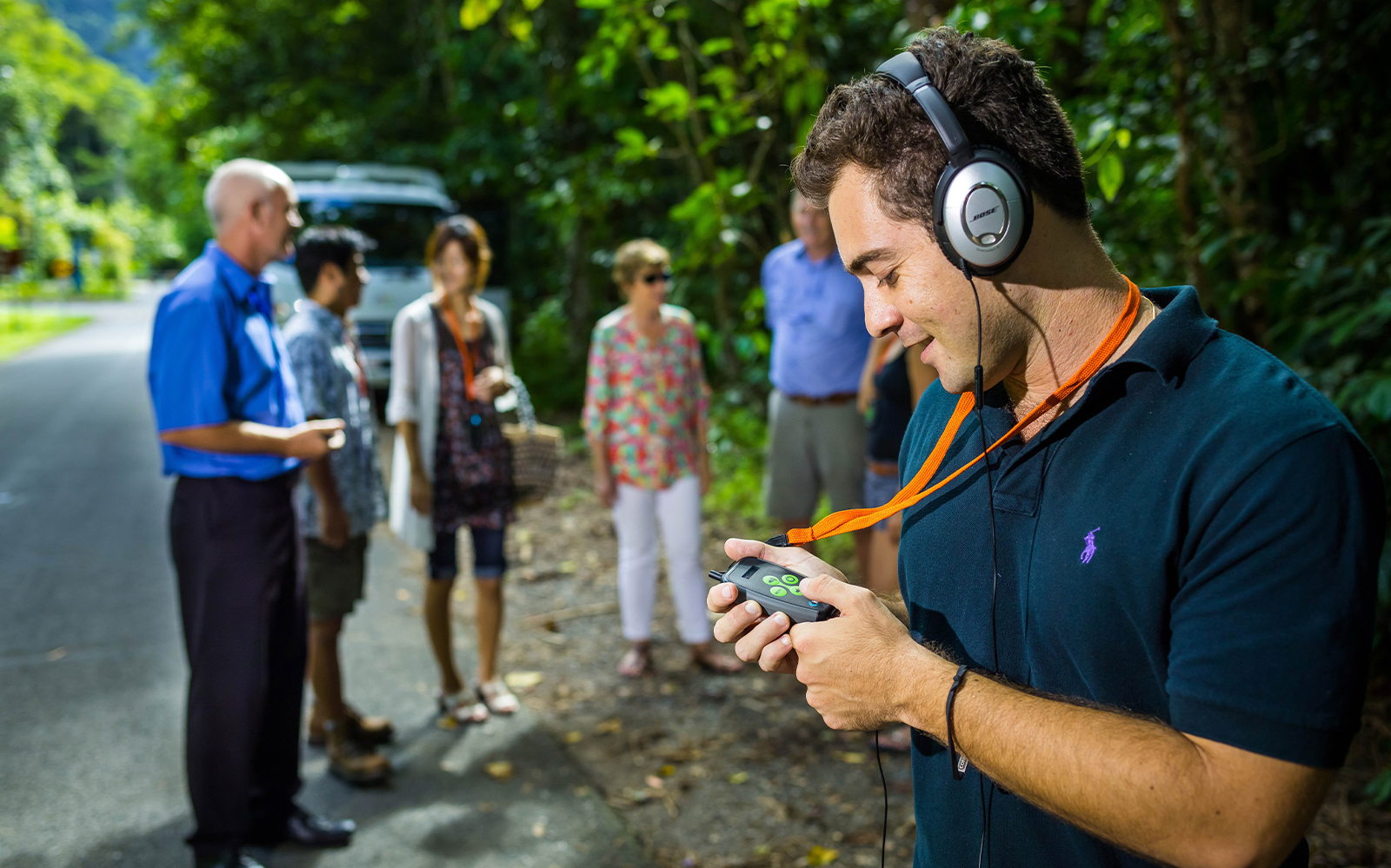 Tourists with audio guides on a guided tour in Daintree Rainforest, Cape Tribulation.