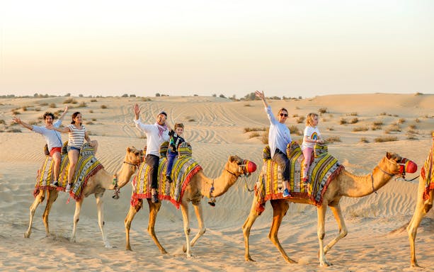 Camel ride in desert during 45 min dune bashing tour.