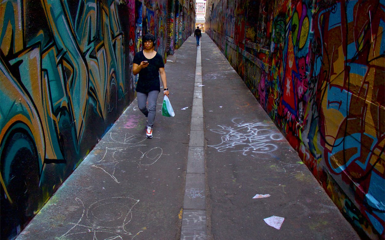 Narrow graffiti-covered alley in Melbourne, part of the Old Melbourne Ghost Tour.
