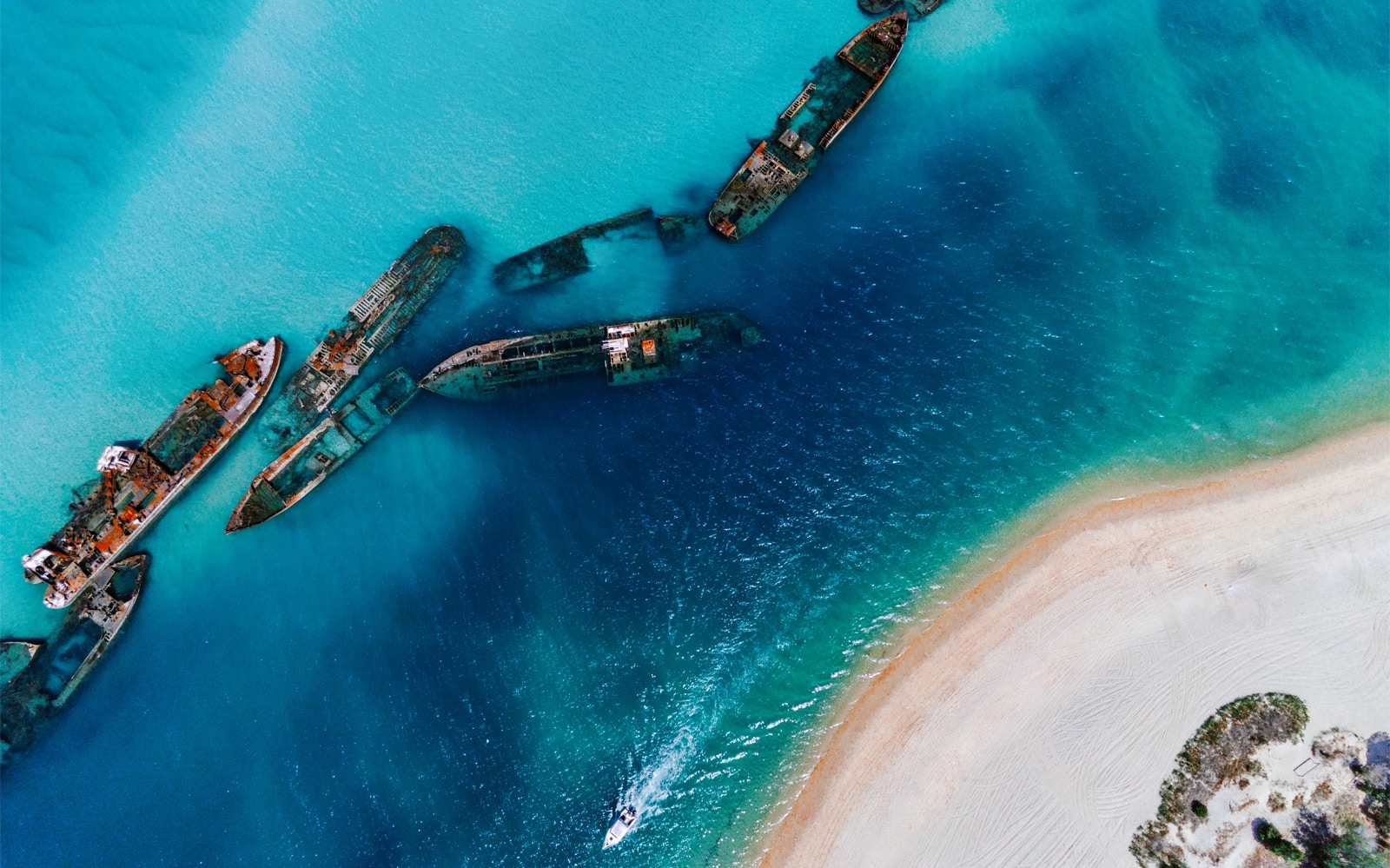 Shipwrecks near Moreton Island in clear blue water, ideal for snorkeling and kayaking.