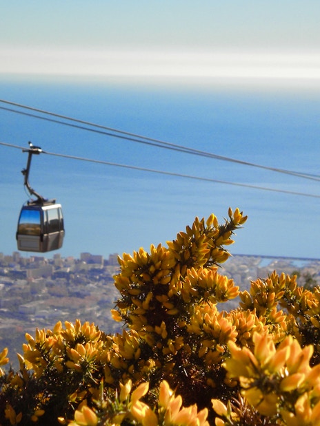 Cable car over Benalmadena with city and sea view in the background.