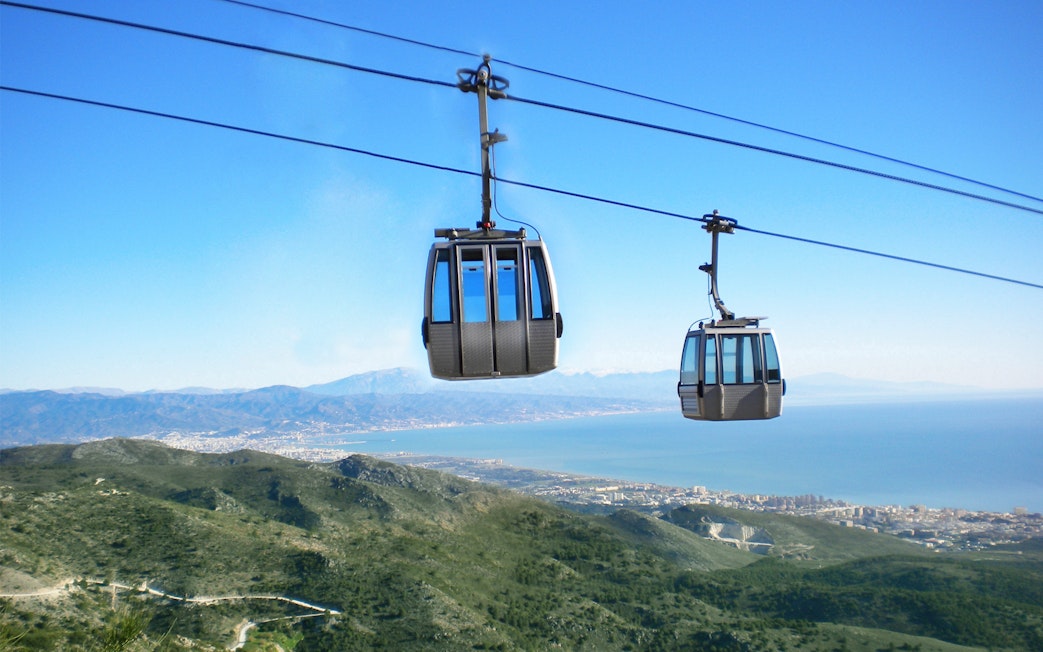 Benalmadena cable cars over mountains with coastal view in Spain.