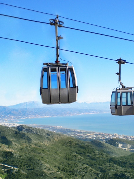 Benalmadena cable cars over mountains with coastal view in Spain.