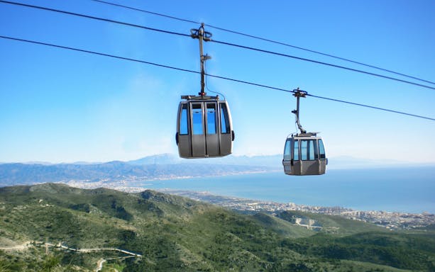 Benalmadena cable cars over mountains with coastal view in Spain.